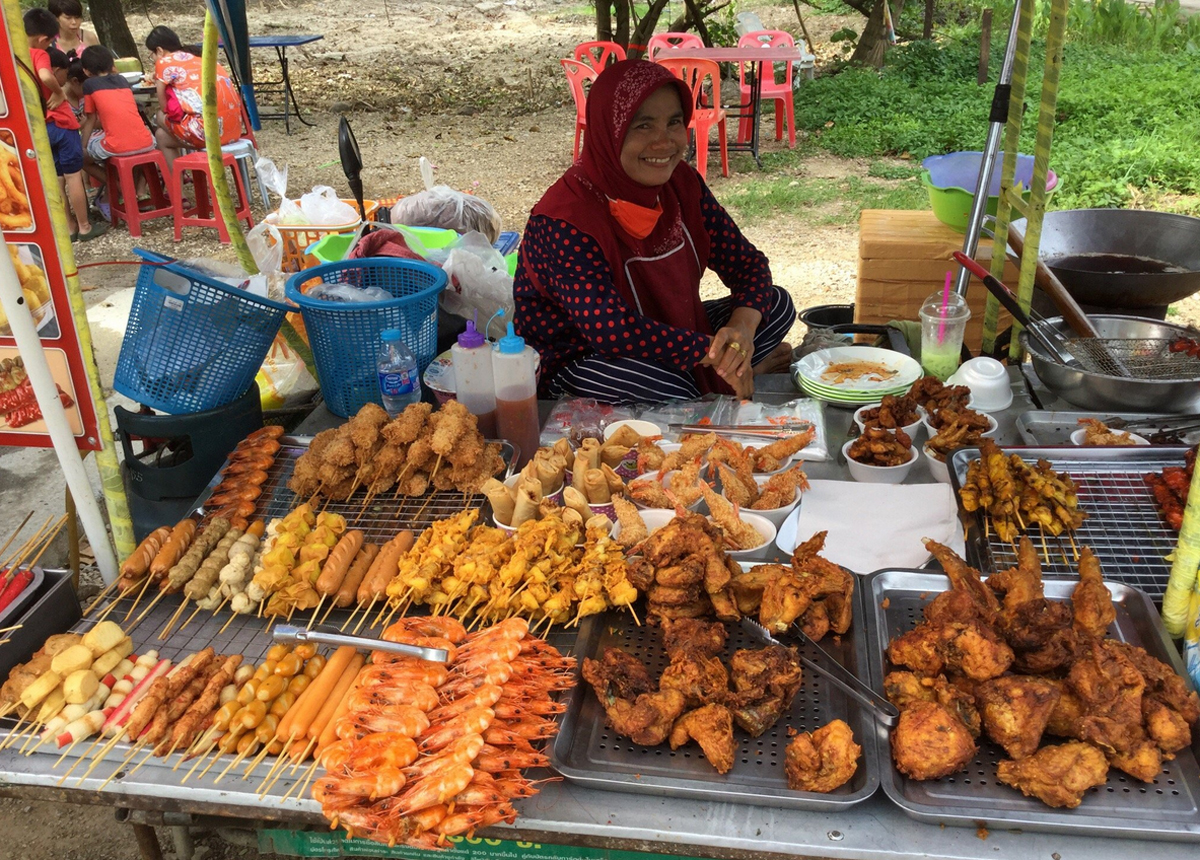 Photo of a local woman selling in Ao Nang In the streets, you can enjoy halal food from local vendors