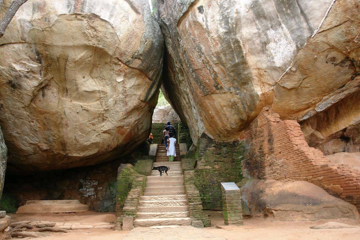 Photo of two huge boulders between which the path passes Stone Gardens