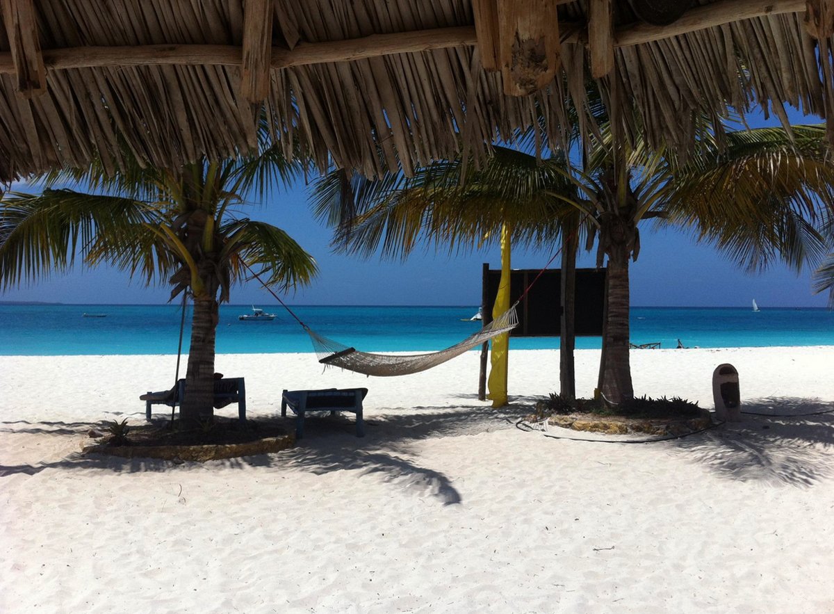 Photo of sun loungers and hammock under palm trees on the beach, Zanzibar Zanzibar Beach Holidays