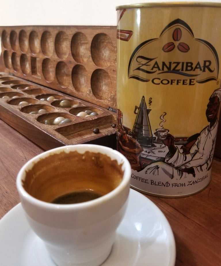 A cup of fofee with a Zanzibar coffee can in the background Coffee is the best gift for connoisseurs
