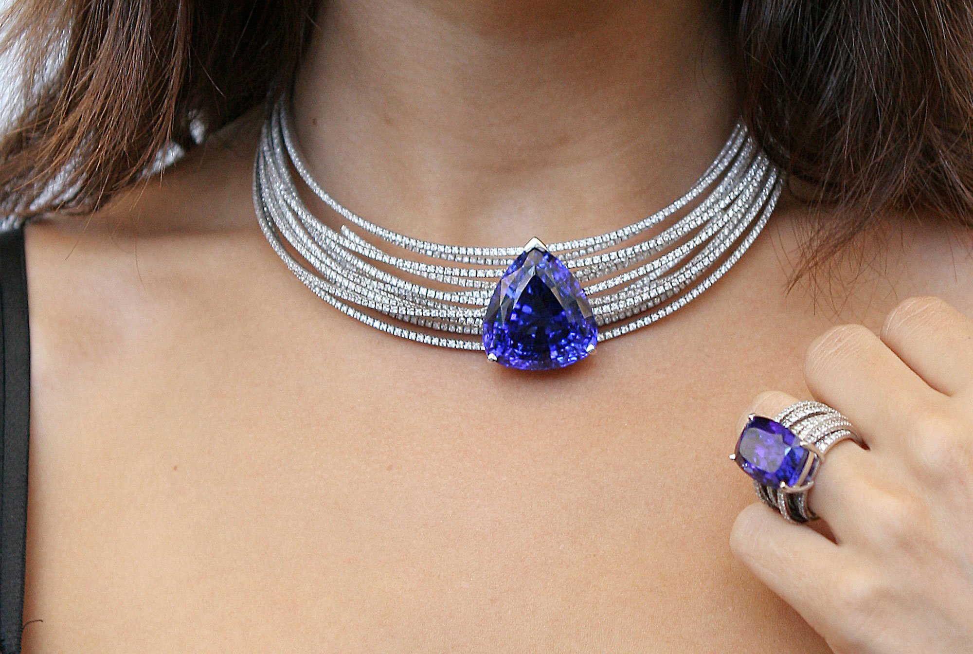 A girl wearing a necklace and a ring with blue tanzanite inserts Jewelry from Tanzania