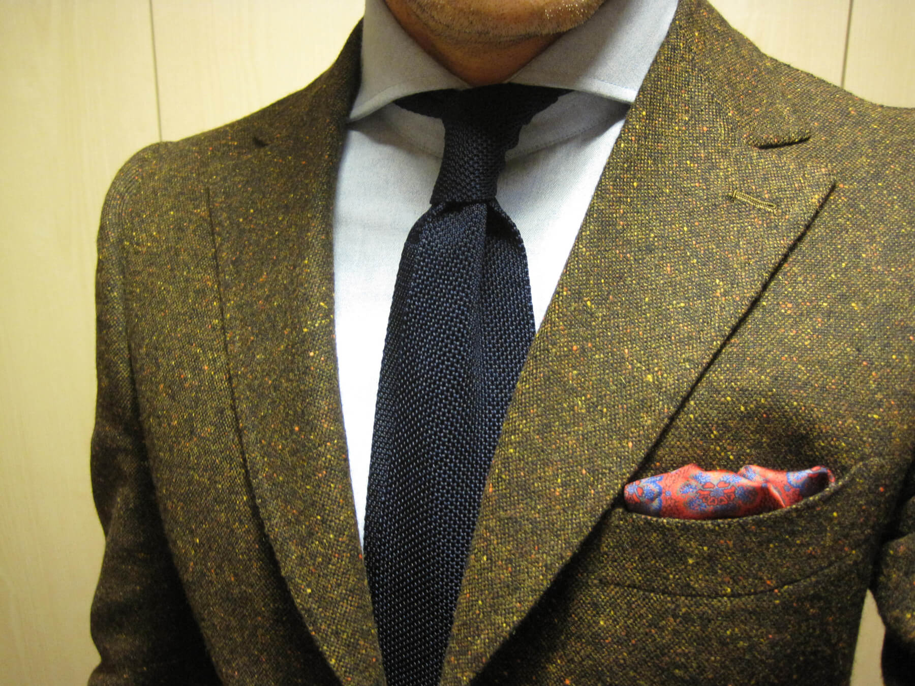 The photo shows a tweed jacket from Donegal Tweed Jacket