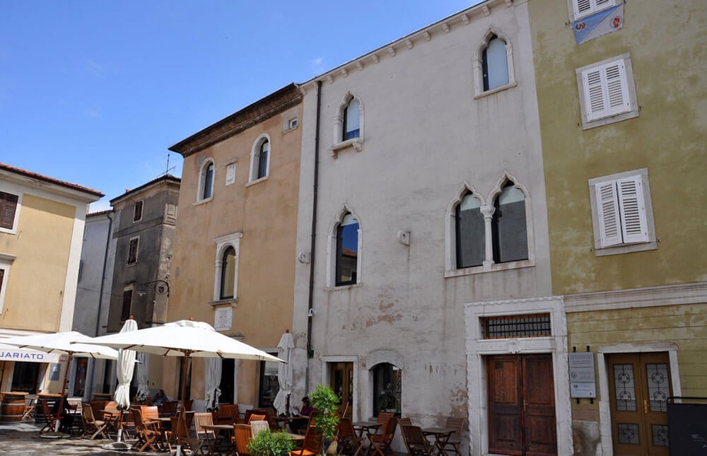 Photo of the Manzioli Palace (white) and the Lavisato House (beige) on Piazza Manzioli The Manzioli Palace (white) and the Lavisato House (beige with semi-circular windows) on Piazza Manzioli