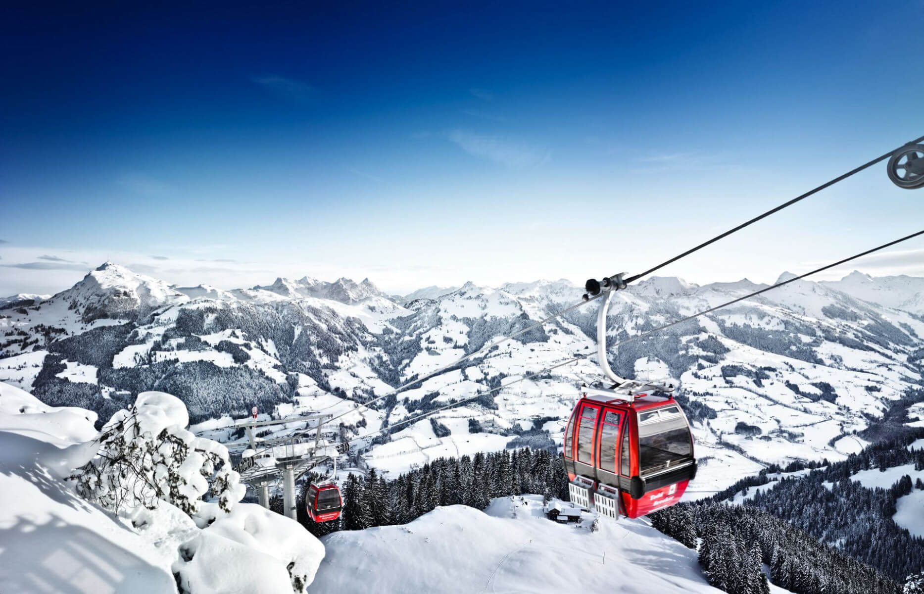 Kitzbühel's ski lifts against the backdrop of the snow-covered Alps Kitzbuhel Ski lifts