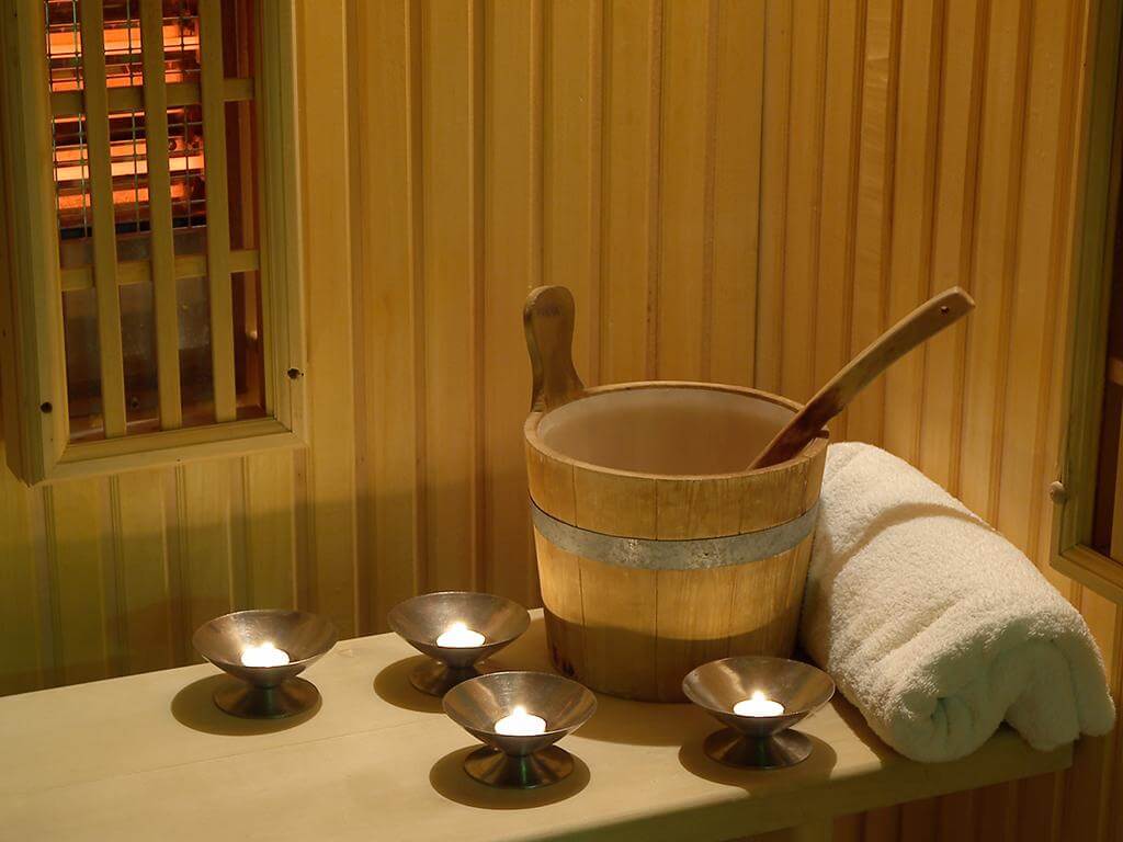 Photo of a bucket with a ladle and a towel in the sauna Sauna trip